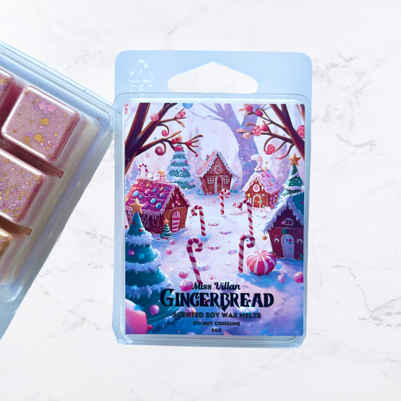 Gingerbread-themed wax melt packaging with a winter village design on a light background.