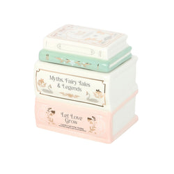Stack of decorative boxes with fairy tale-themed text on a white background -oil burner- wax melter