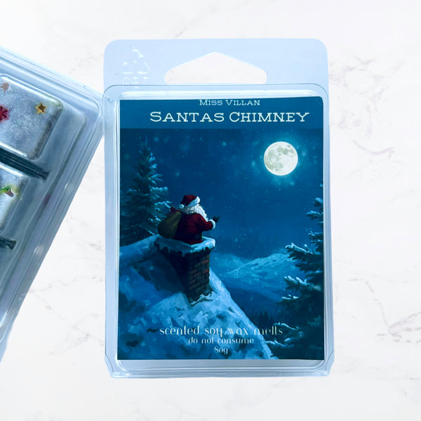 Wax melt package with Santa Claus on a chimney against a snowy night sky.