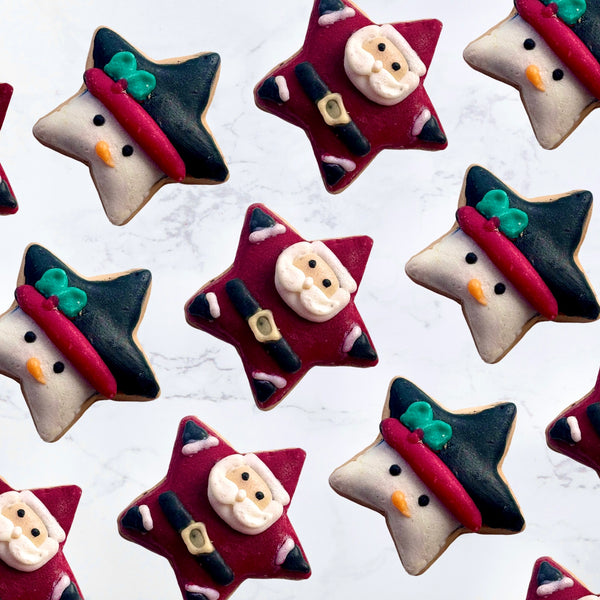 Decorative cookies shaped like stars with Santa Claus faces on a white background- wax melts